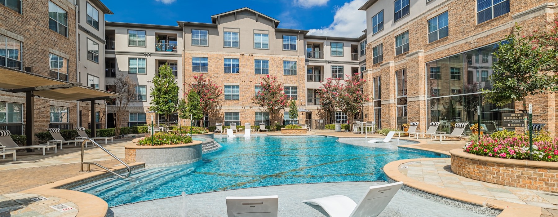 a swimming pool in a courtyard between buildings